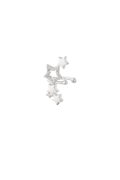 Silver star-shaped ear cuff with zircon crystals on white background