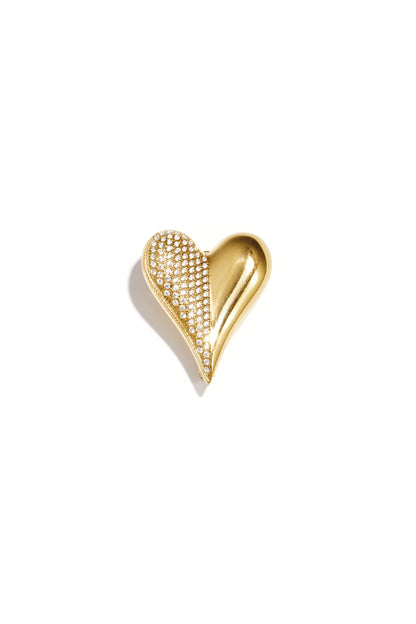 Gold heart-shaped brooch half covered with clear rhinestones on white background