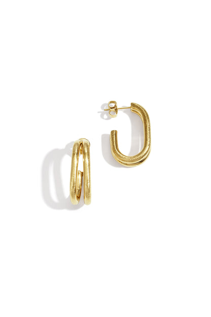 Close-up of gold chunky double loop earrings with textured finish on white background