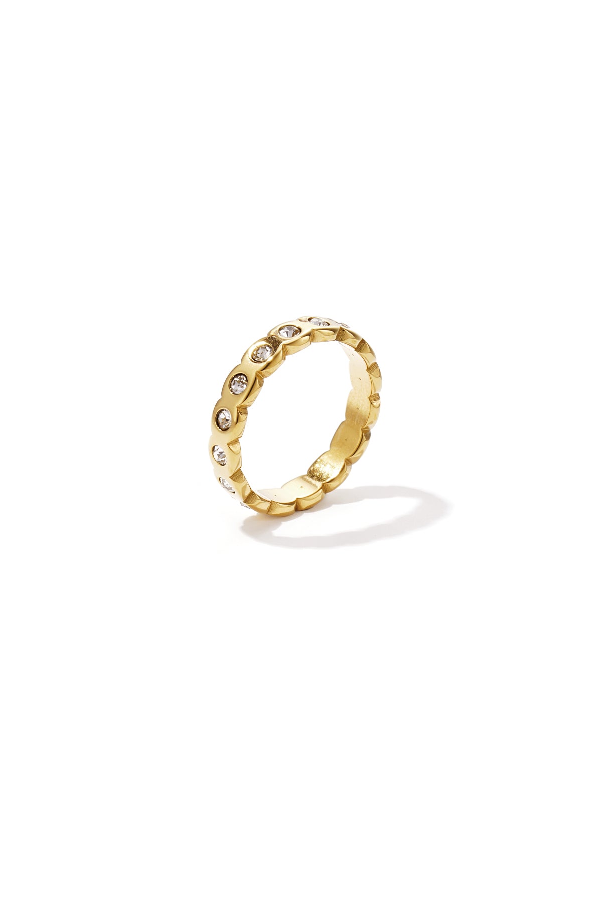 Gold ring with clear crystal accents on a white background