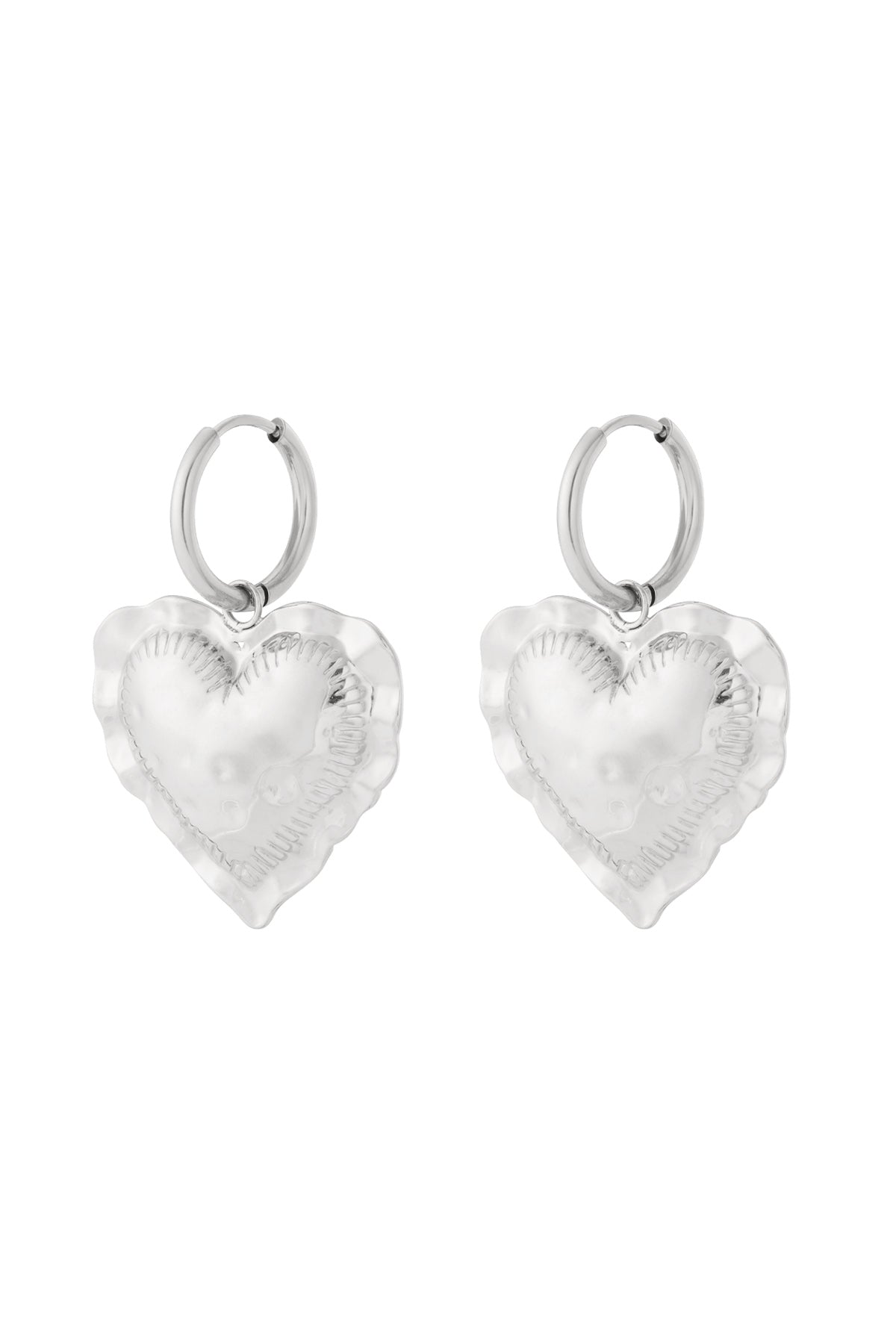 Pair of silver tone heart drop hoop earrings with hammered texture on white background