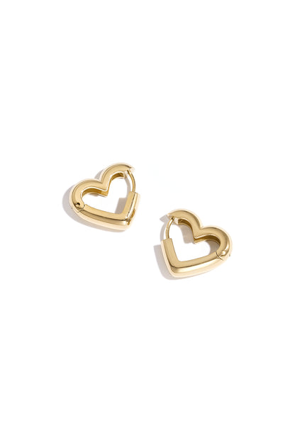 Pair of gold heart-shaped hoop earrings with smooth polished finish on white background