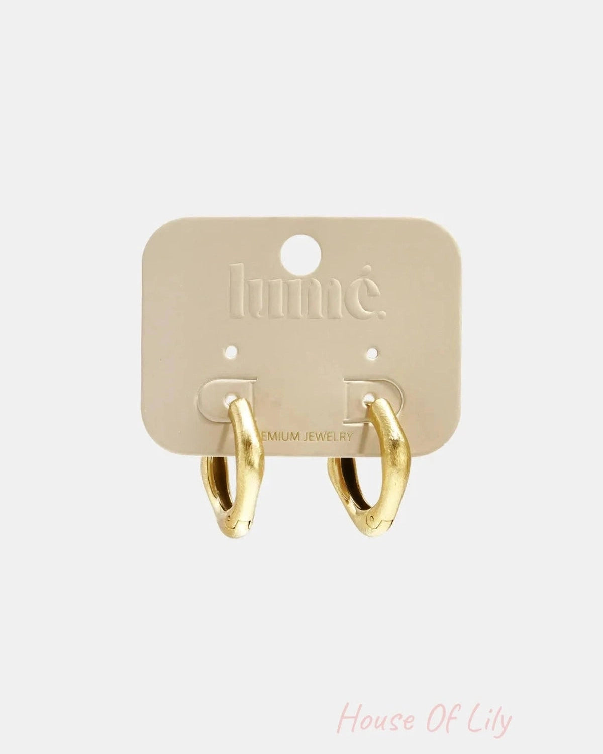 Two thick, gold-colored rectangular hoop earrings mounted on a beige display card.