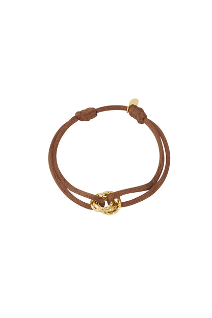Beige knot charm bracelet with gold-plated twisted knot pendant on white background