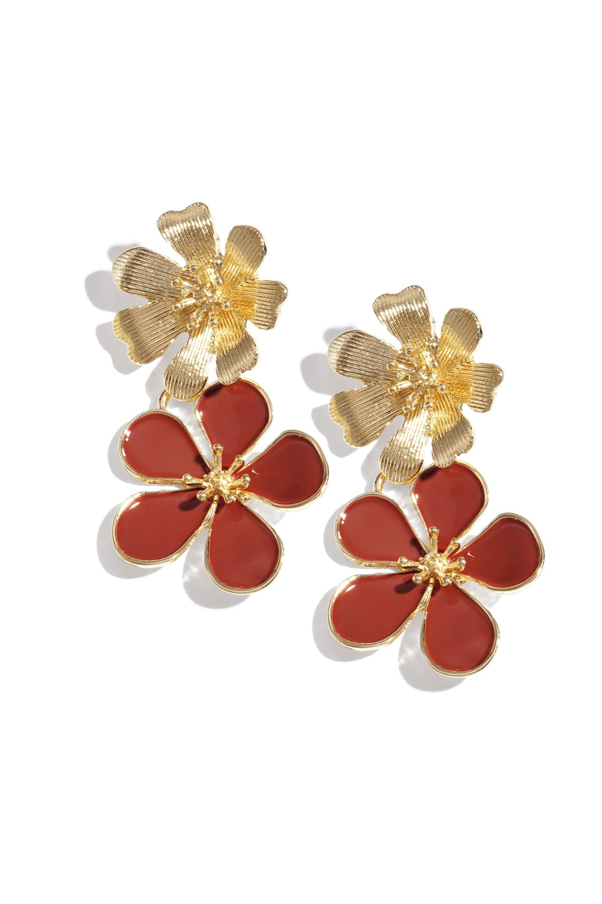 Pair of gold-tone drop earrings with textured top flower and pink enamel bottom flower on white background