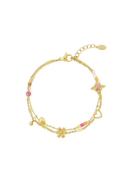 Gold-tone double chain charm bracelet with flower, heart, and star charms with pink crystal and colorful enamel beads.