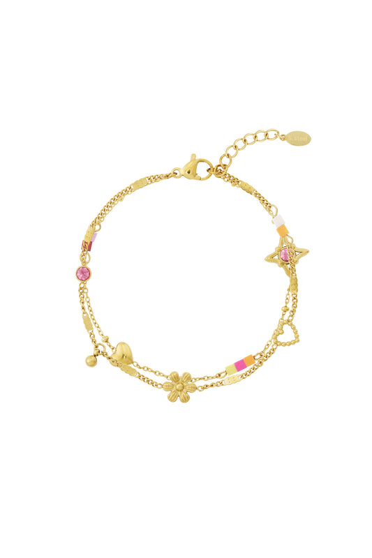 Gold-tone double chain charm bracelet with flower, heart, and star charms with pink crystal and colorful enamel beads.