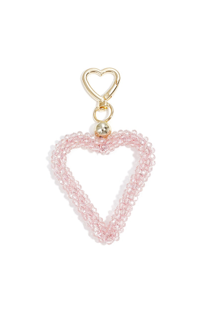 Pink beaded heart keychain with gold heart-shaped clasp on white background