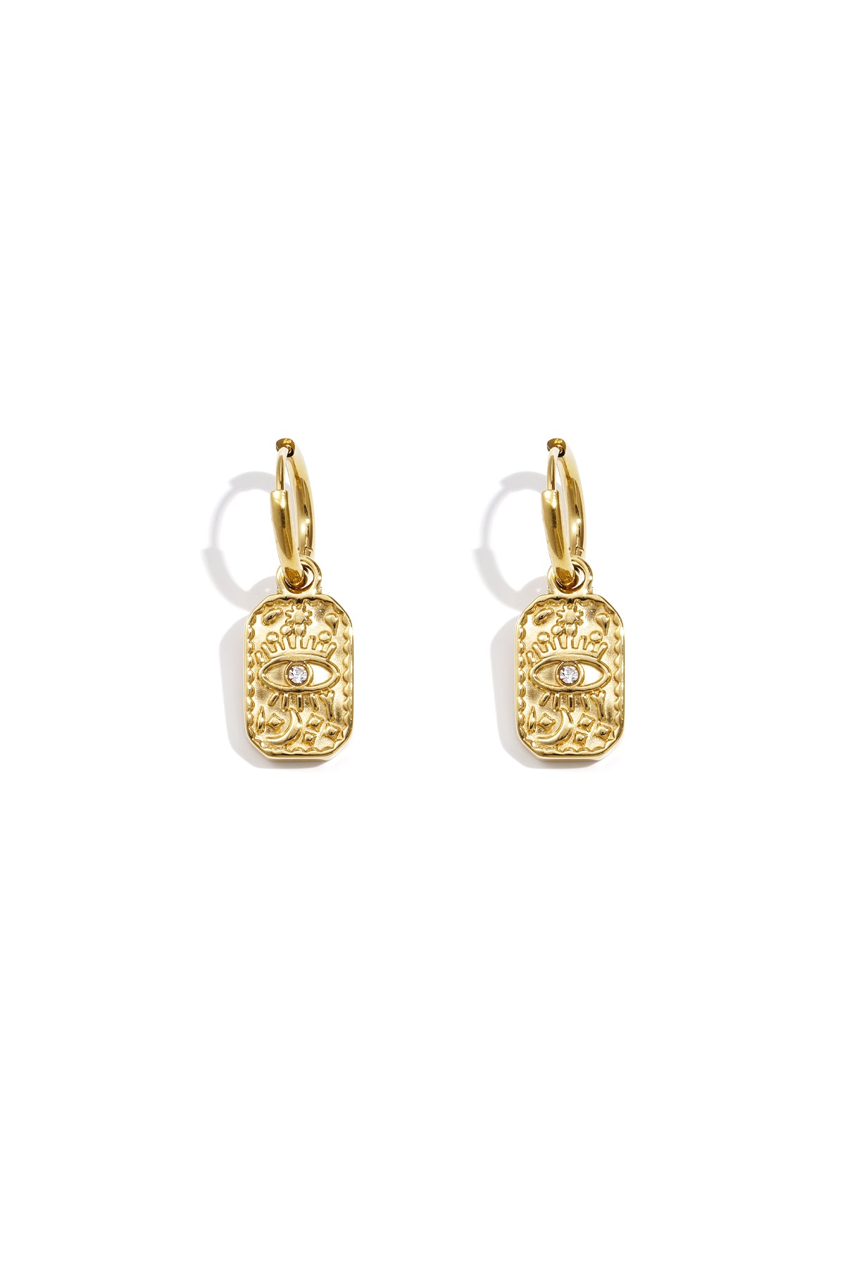 Pair of gold hoop earrings with rectangular charm featuring an embossed eye design and central rhinestone on white background