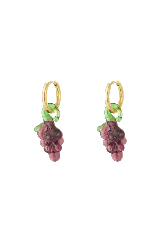 Pair of gold hoop earrings with translucent purple glass grape charms and green vines on a white background