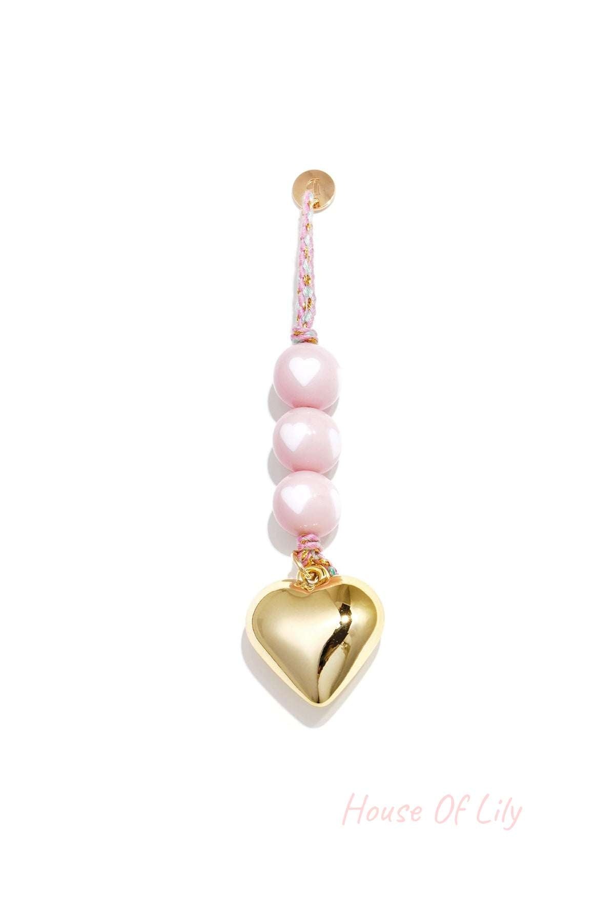 Light pink heart charm bag keychain with glossy beads and gold heart pendant on braided pink cord