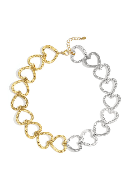 Two-tone heart link chain necklace featuring gold and silver hammered heart links on white background