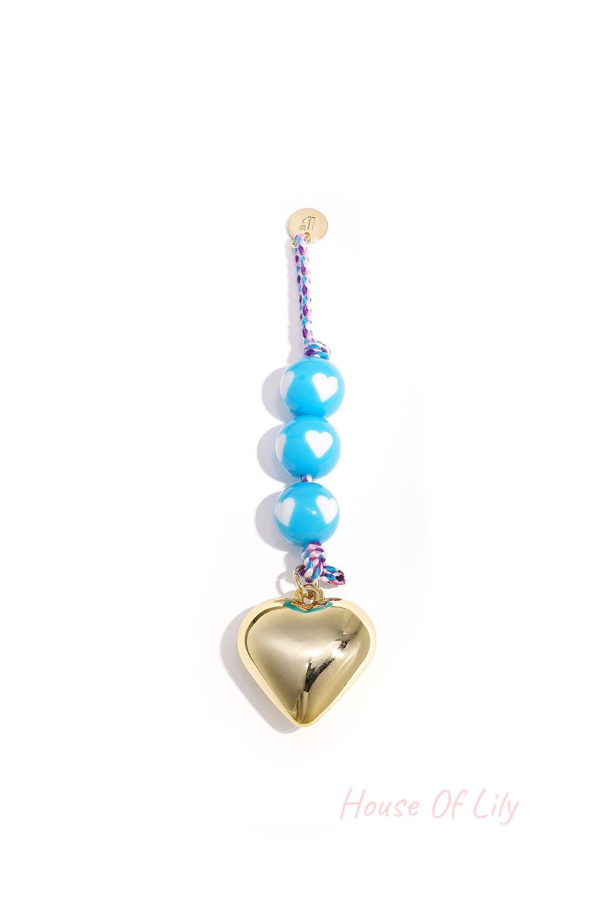 Baby blue heart charm bag keychain with white heart patterned round beads and shiny gold heart pendant on braided blue cord