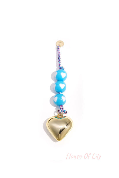 Baby blue heart charm bag keychain with white heart patterned round beads and shiny gold heart pendant on braided blue cord