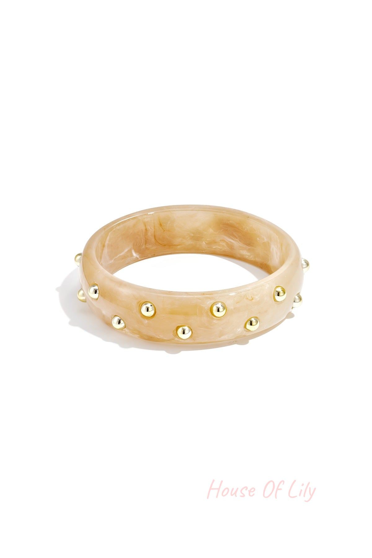 Beige marble resin bangle featuring gold stud details on white background