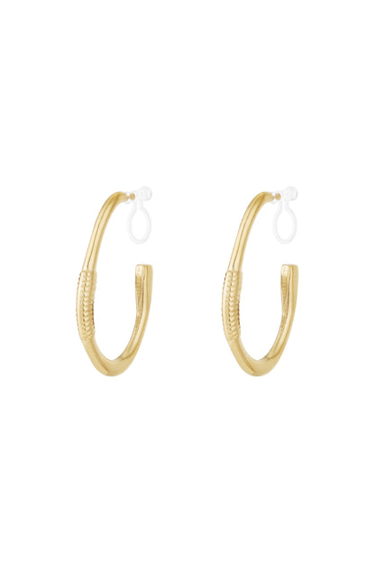 Pair of gold textured hoop clip-on earrings on white background