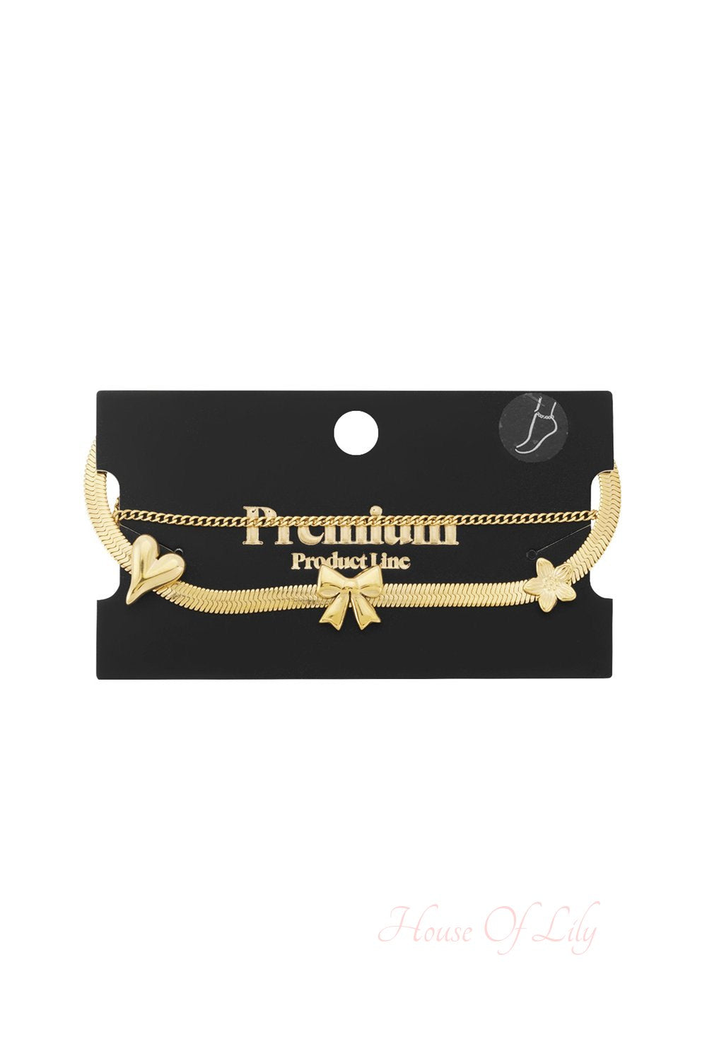 Dainty gold double-chain anklet featuring a flat snake chain with heart, bow, and flower charms on a display card.