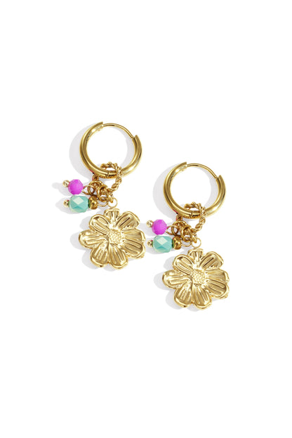 Gold hoop earrings with dangling flower charms and pink and turquoise beads on white background