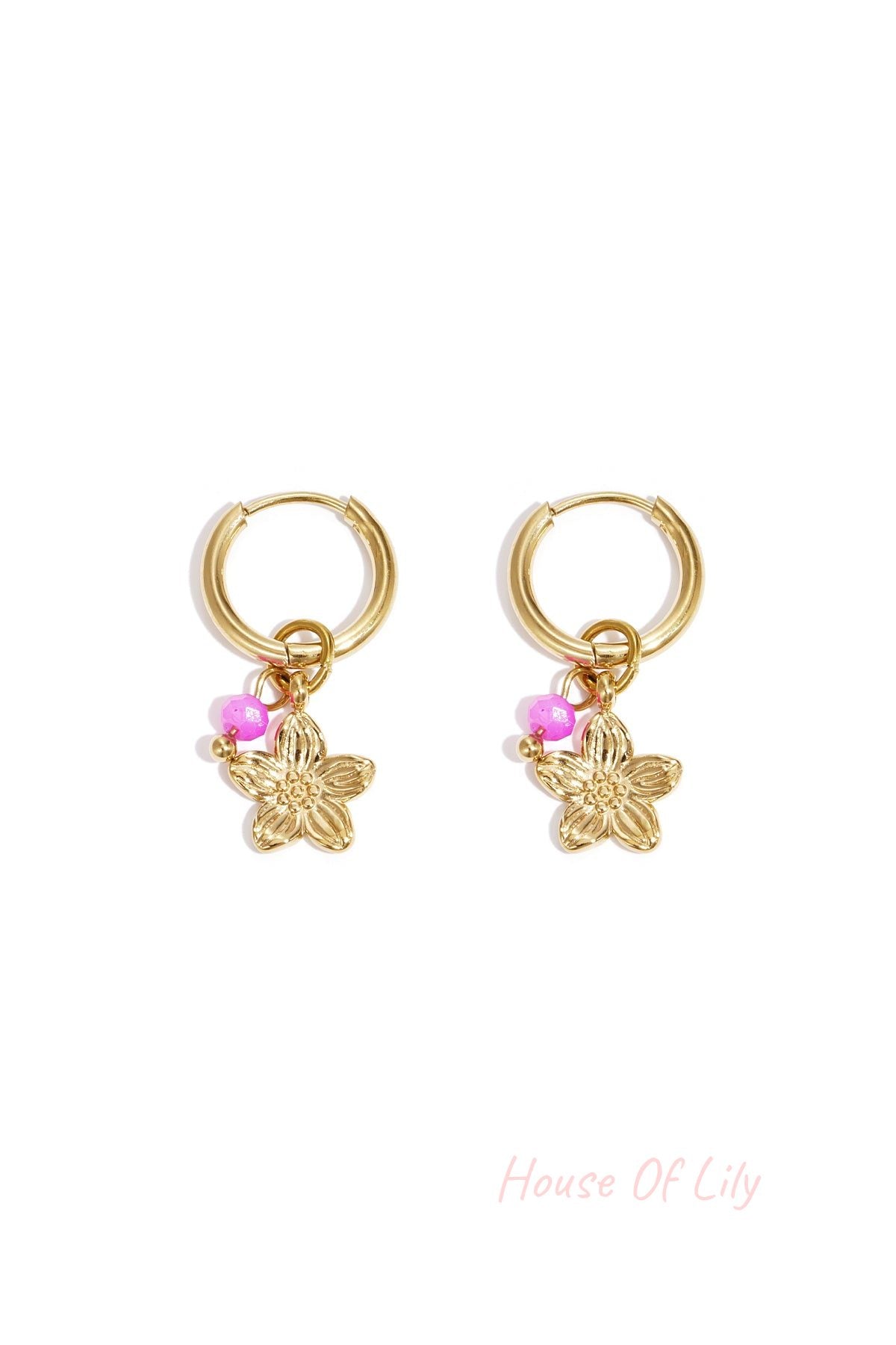 Pair of gold hoop earrings with a gold flower charm and bright pink bead on white background