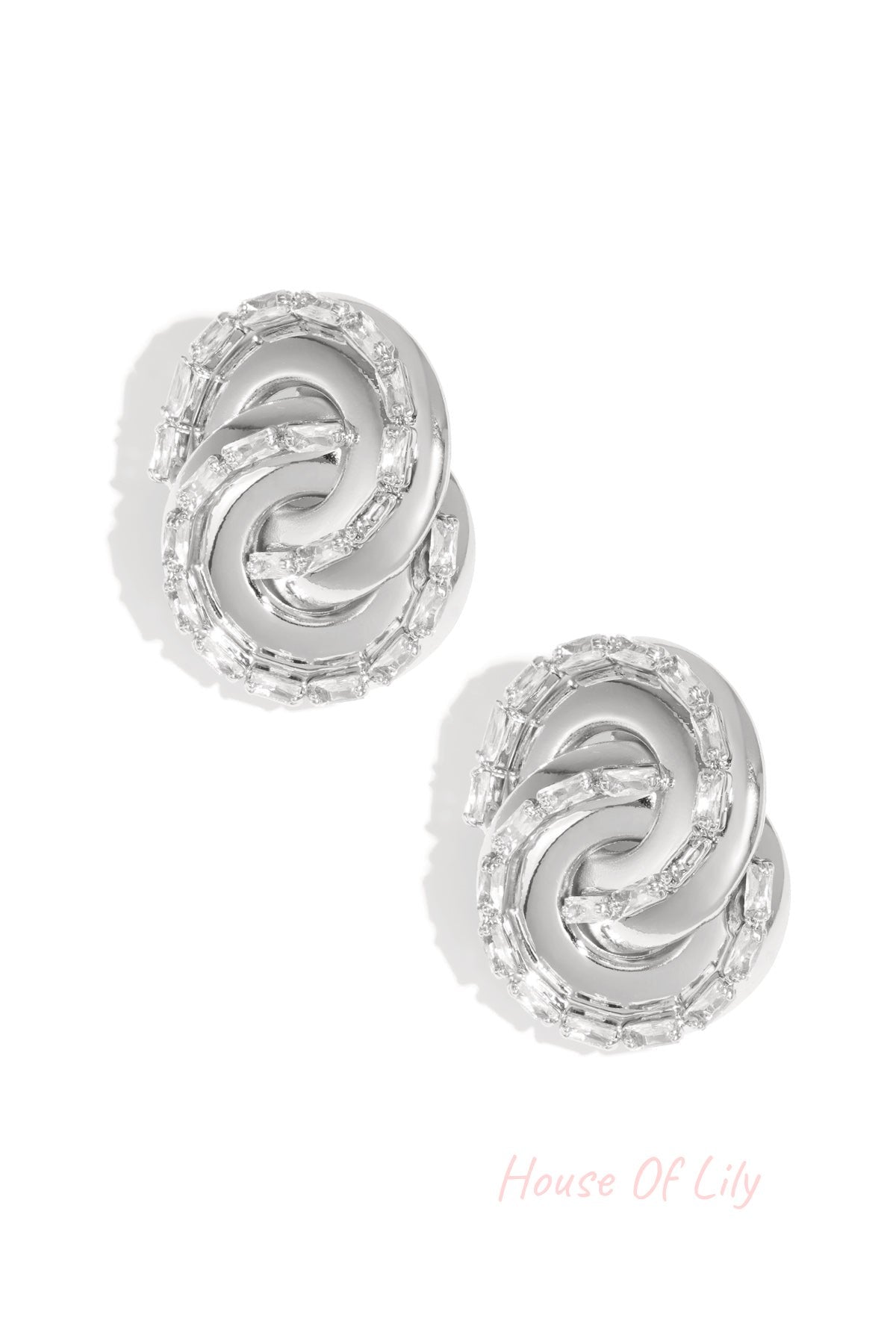 Silver-toned twisted chain stud earrings with baguette-cut crystals on white background