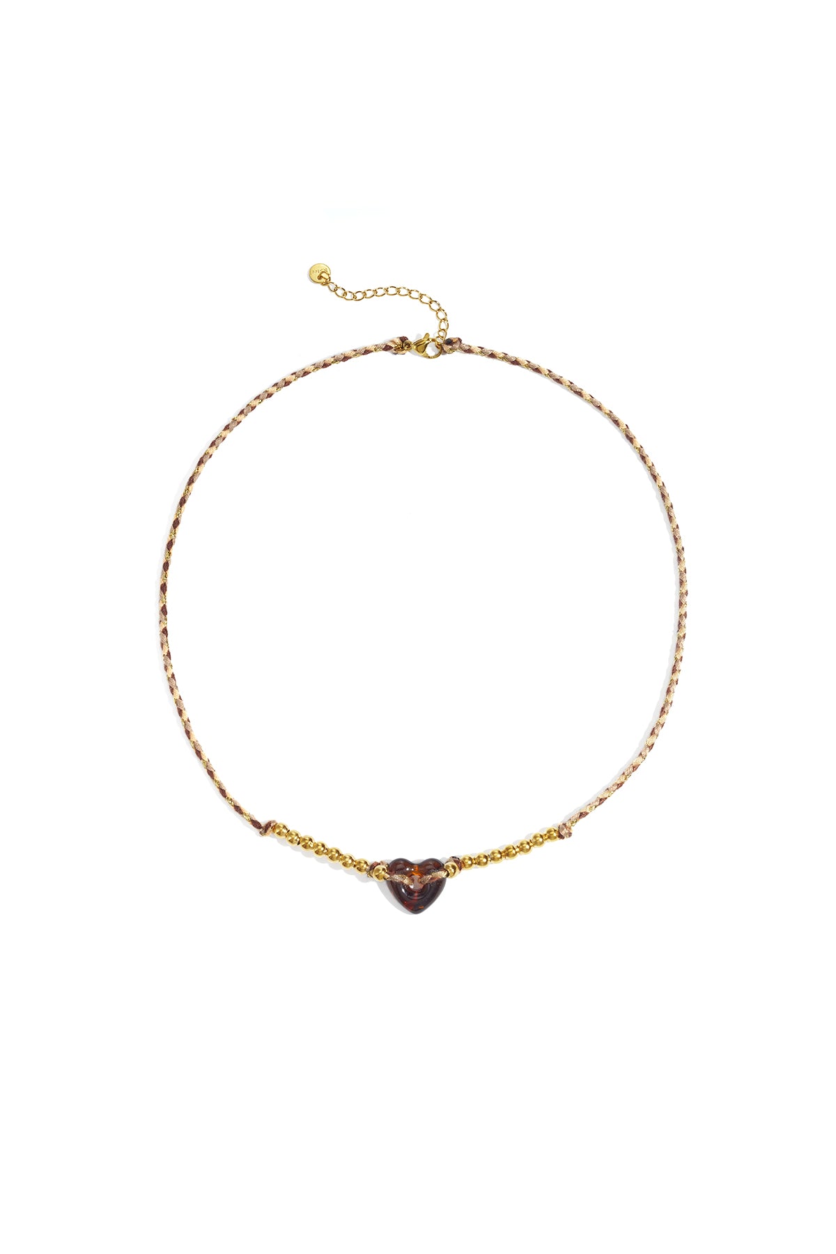 Brown and cream braided necklace with amber translucent heart bead and gold-tone beads against white background