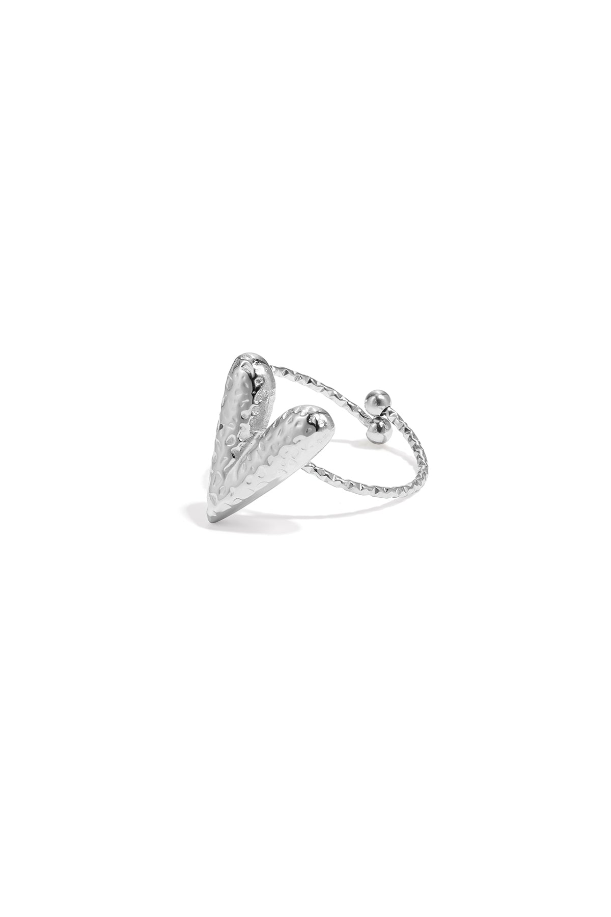 Close-up of hammered silver-tone heart-shaped statement ring with adjustable open band on white background