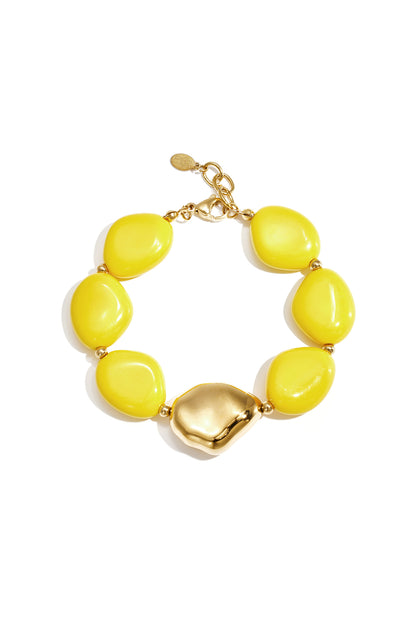 Chunky bracelet with bright yellow irregular acrylic beads and gold-tone clasp and centerpiece