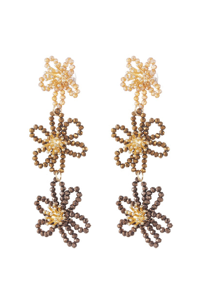 Front view of dark brown floral beaded dangle earrings with golden centers