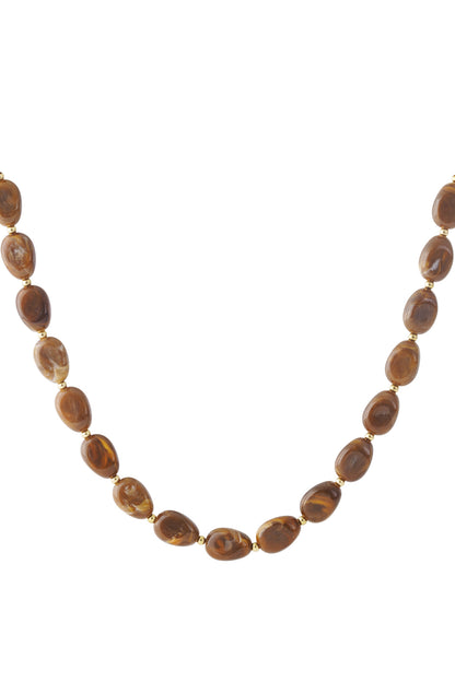 Brown acrylic beaded necklace with gold spacer beads displayed on white background
