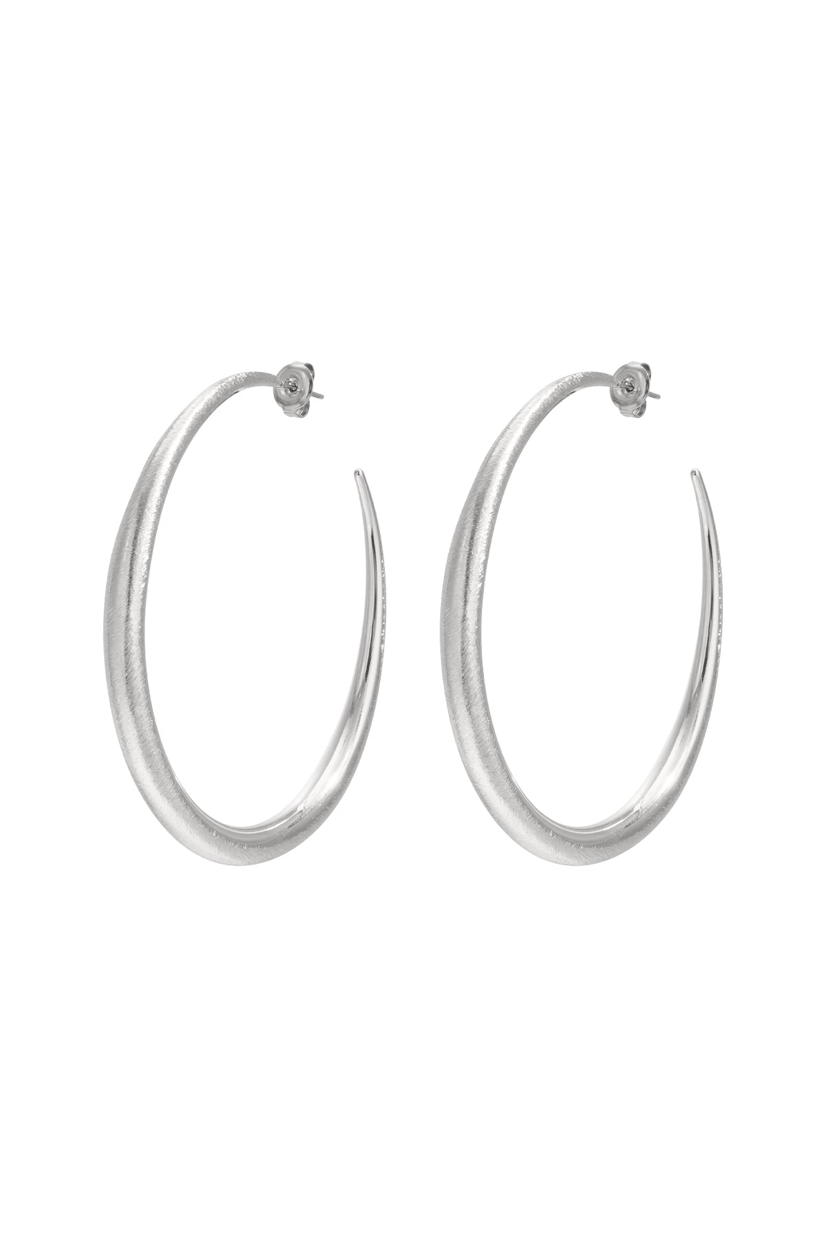 Pair of sculpted silver hoop earrings with tapered design on white background