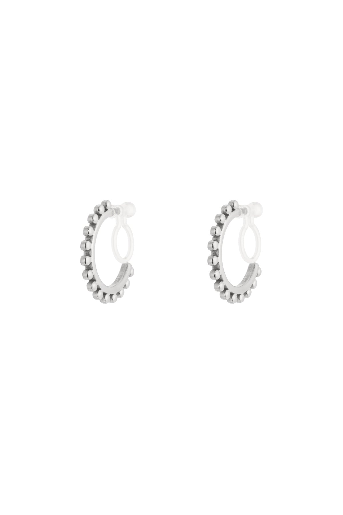 Pair of silver-tone beaded hoop clip-on earrings with clear silicone backings isolated on white background