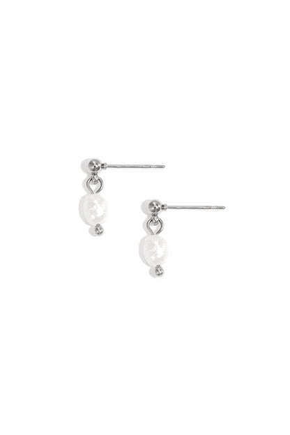 Pair of delicate silver-tone drop earrings with irregular freshwater pearls on white background