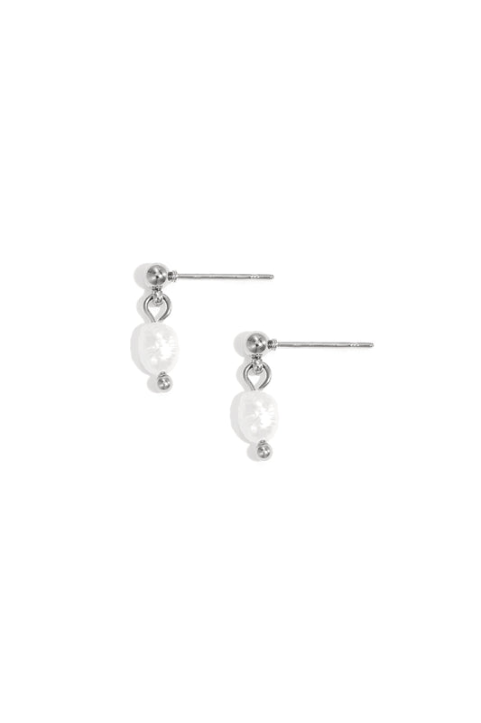 Pair of delicate silver-tone drop earrings with irregular freshwater pearls on white background