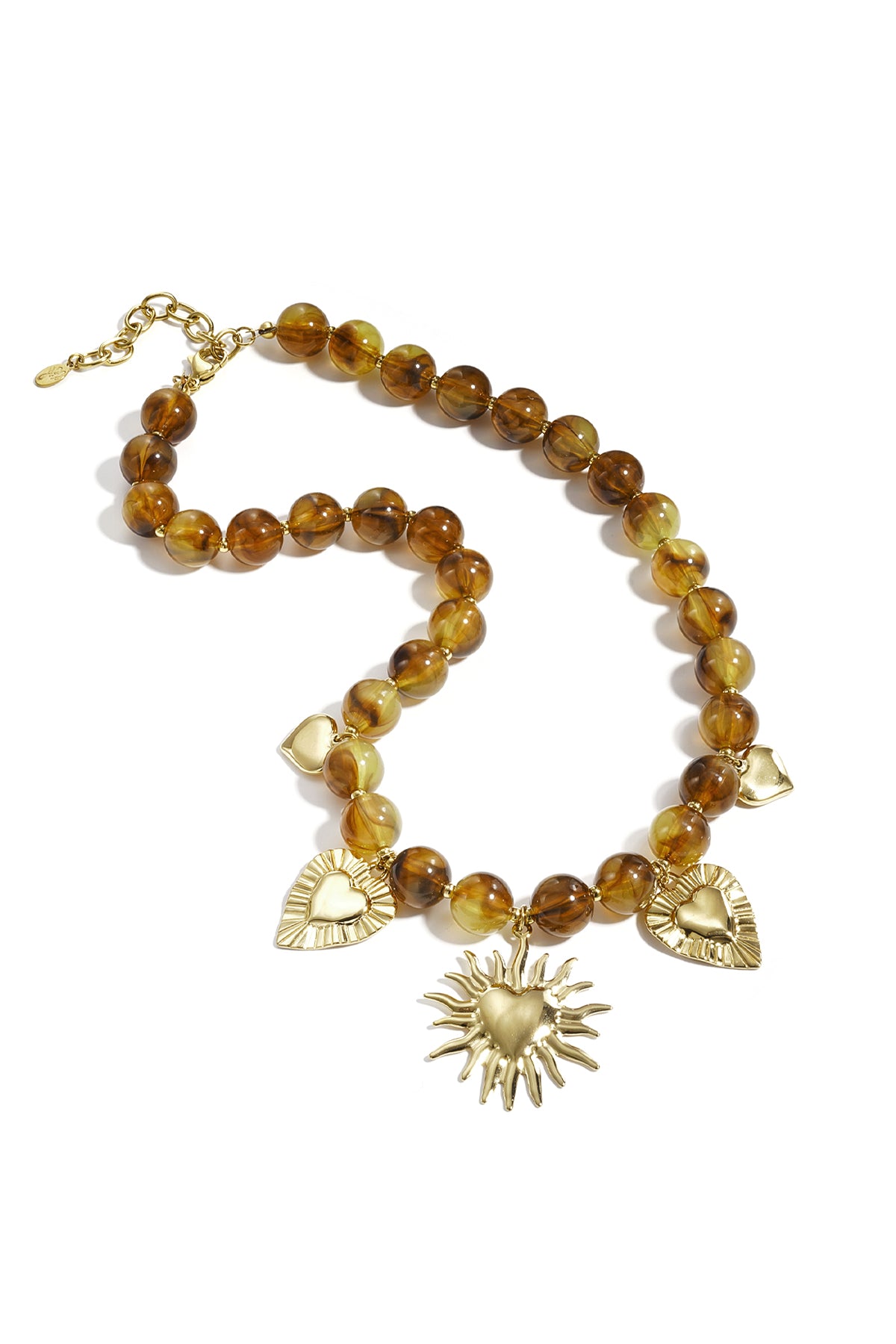 Amber brown beaded necklace with gold heart and sun charms laid flat on white background