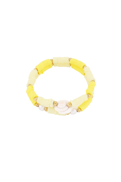 Yellow shell charm beaded bracelet with gold and polymer clay beads on white background