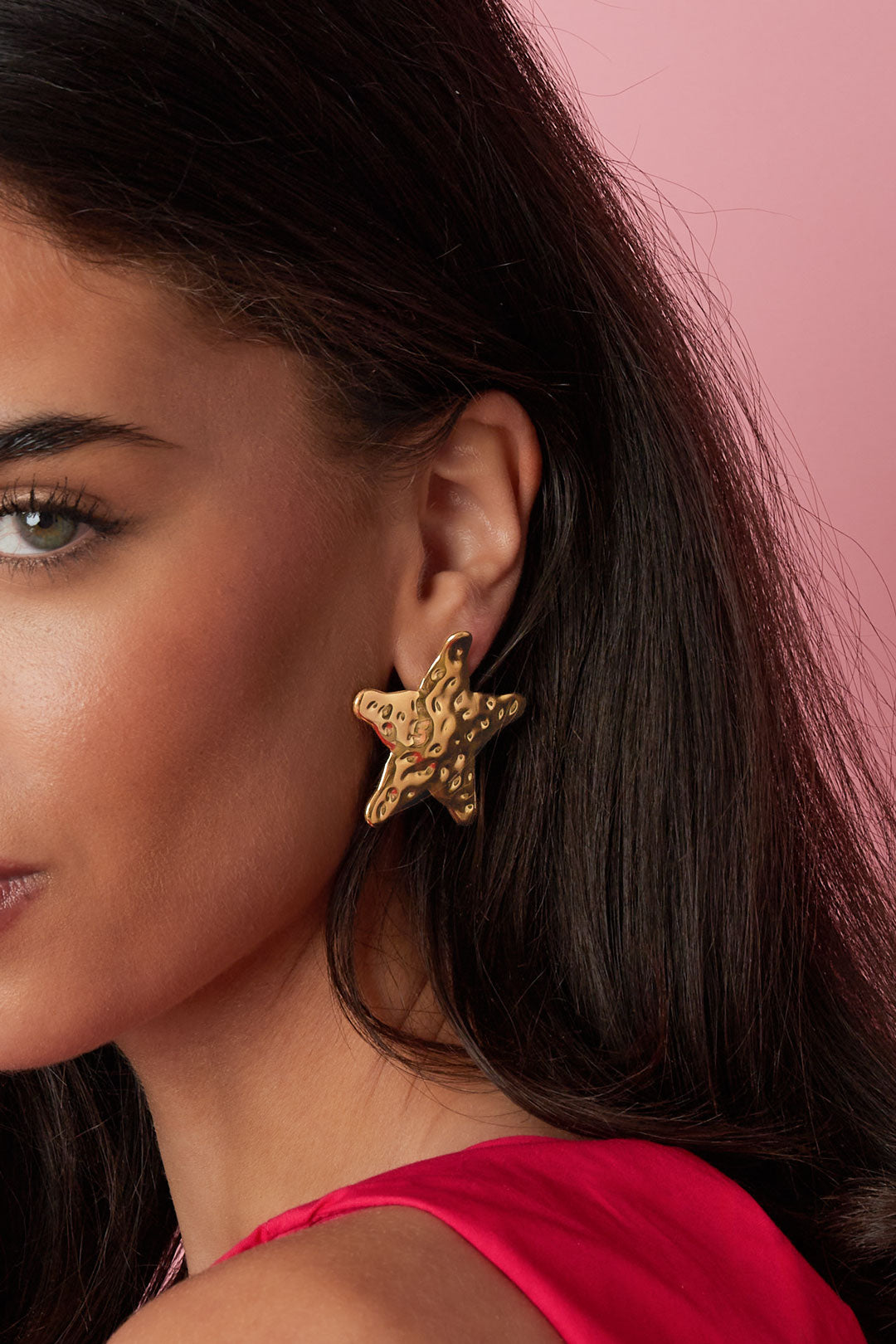 Close-up profile of model showcasing the gold textured starfish stud earring