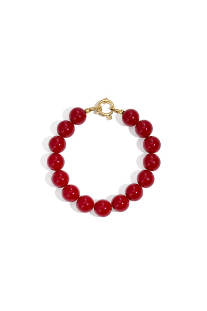 Bright green resin bead bracelet with gold toggle clasp on white background
