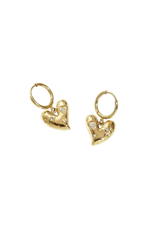 Pair of gold heart charm drop hoop earrings with rhinestone accents on white background