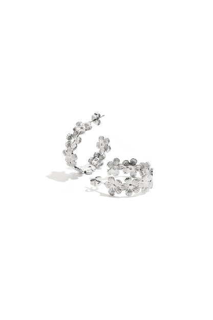 Pair of silver-tone hoop earrings with the same floral design on a white background.