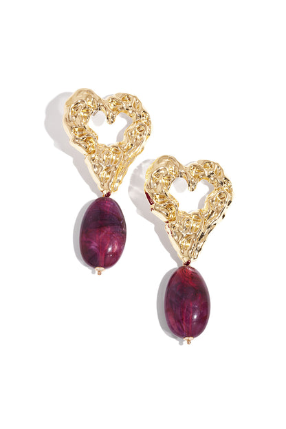 Pair of gold-tone textured heart earrings with vibrant purple marbled resin drop pendants on white background