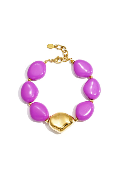 Chunky bracelet with vibrant purple irregular acrylic beads and gold-tone clasp and centerpiece