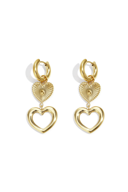 Pair of gold-toned heart charm hoop earrings with layered heart pendants on a white background