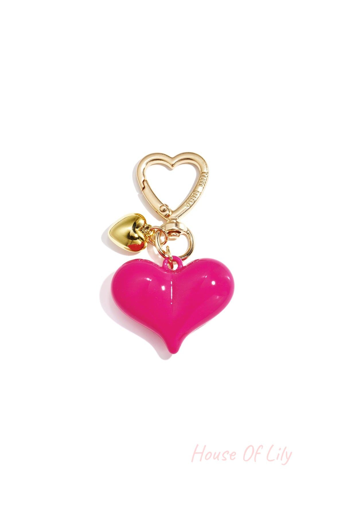 Single hot pink acrylic heart bag charm with gold heart clasp and mini gold heart pendant on white background