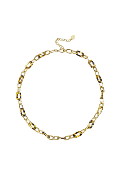Tortoise link chain necklace laid flat on white background showing gold and brown resin links.