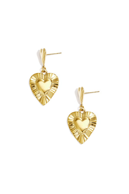 Pair of gold-tone heart shaped drop earrings with textured outer edge on white background