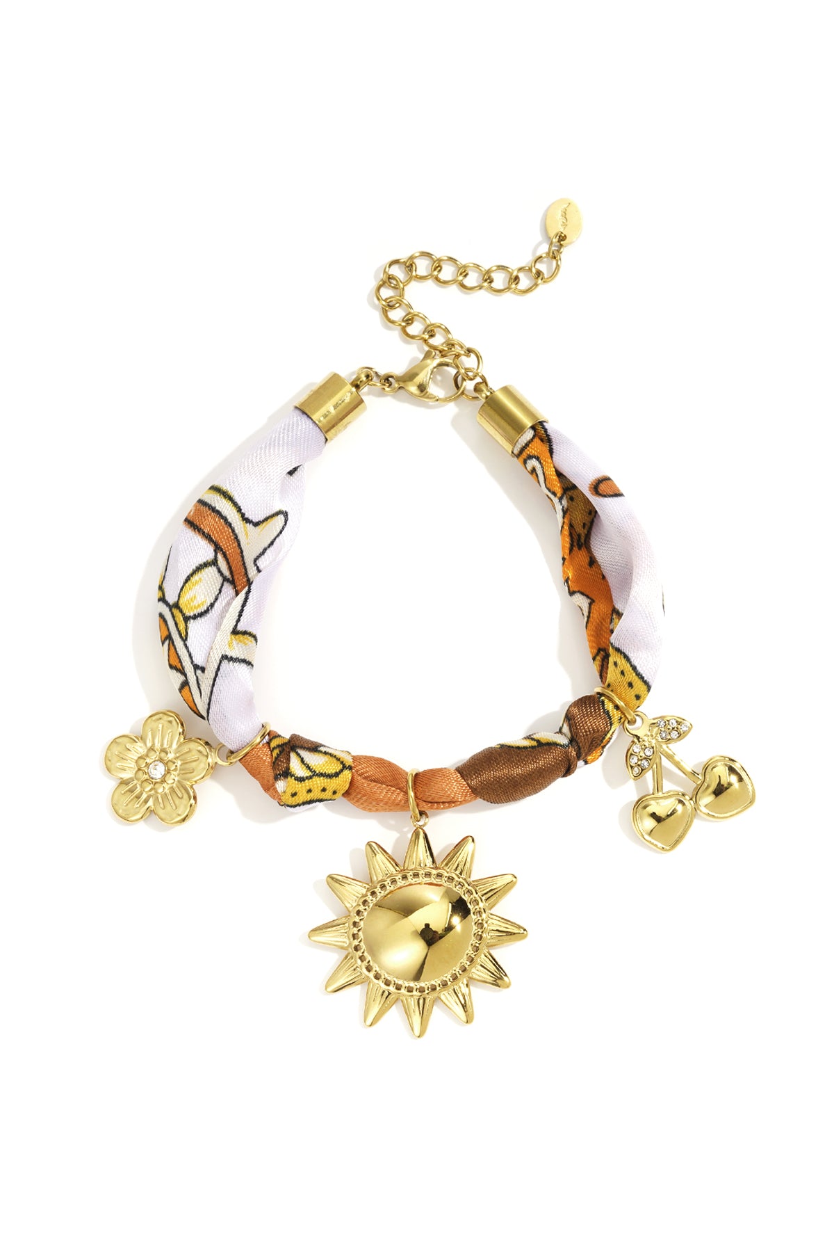 Gold-tone charm bracelet with sun, cherry, and flower charms on a orange, brown, and white patterned fabric band with adjustable clasp