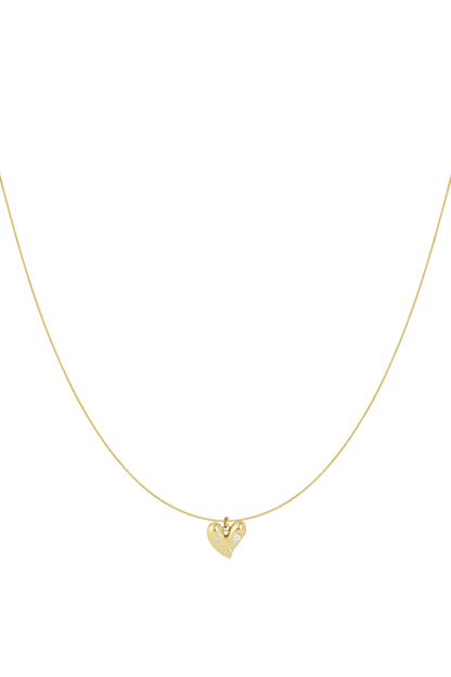 Minimalist gold heart pendant necklace with rhinestones on thin chain isolated on white background