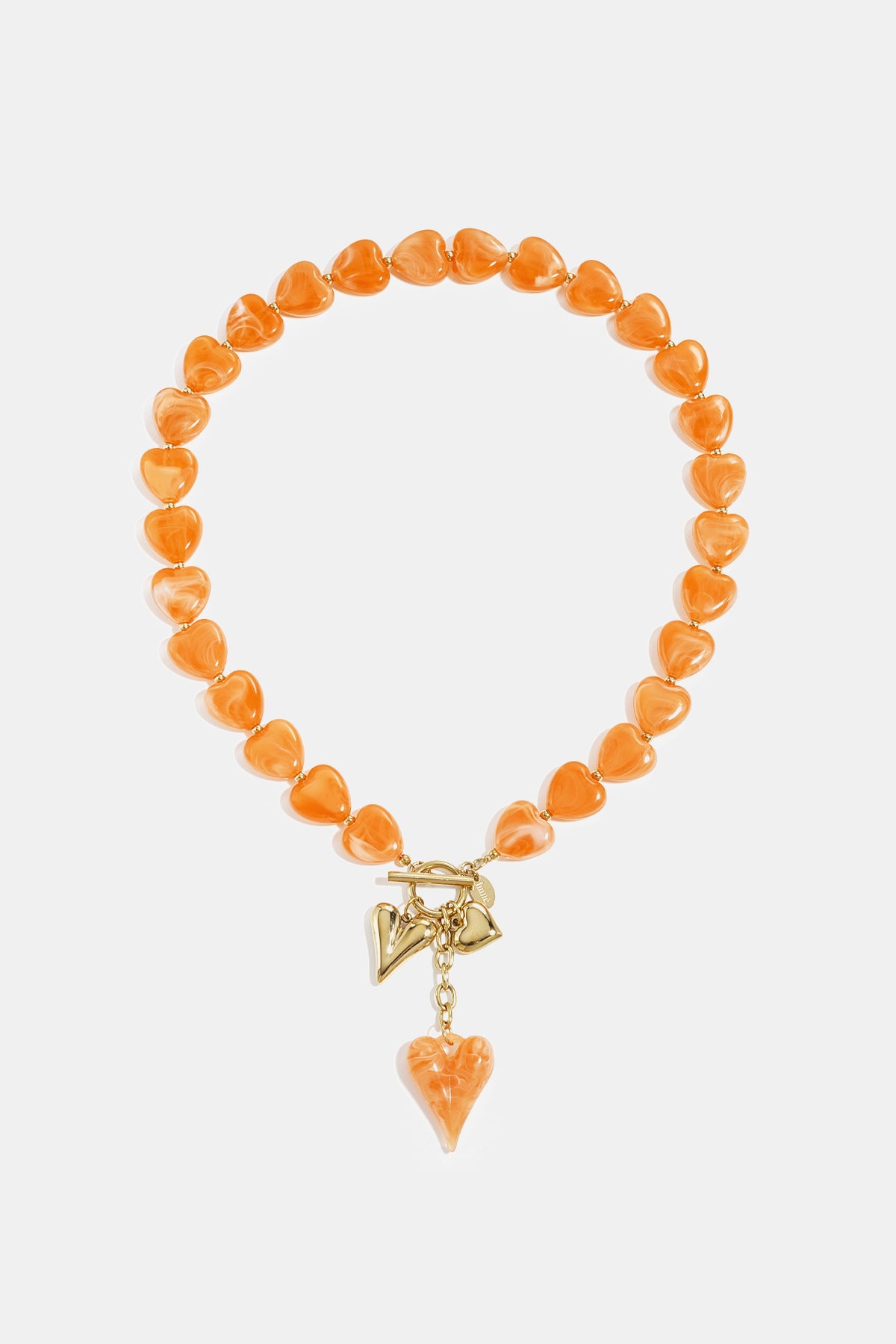 Orange heart-shaped bead necklace with gold-tone charms on white background