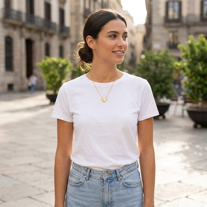 Full-body view of a woman wearing the Love Struck Chain necklace outdoors, highlighting its reflective qualities against a cityscape.