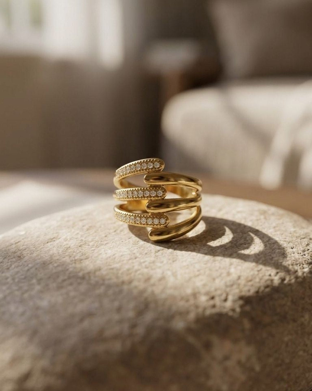 Close-up of Glam Multi Band ring with sparkling rhinestones on a stone surface, emphasizing its delicate design and petite size in natural light.